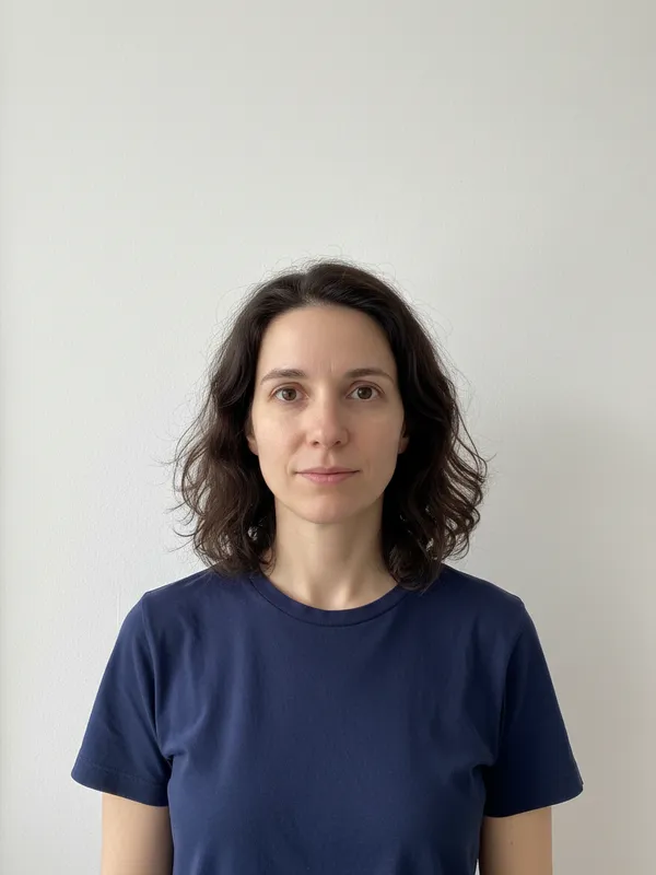 A woman photographed against a plain white wall