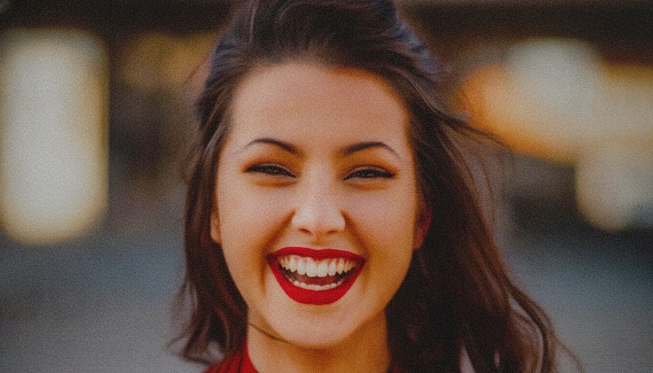 Portrait of a smiling woman taken in low light — After
