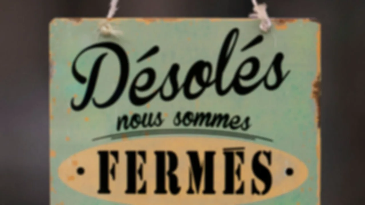 Blurry hanging shop sign with readable, sharpened lettering — Before