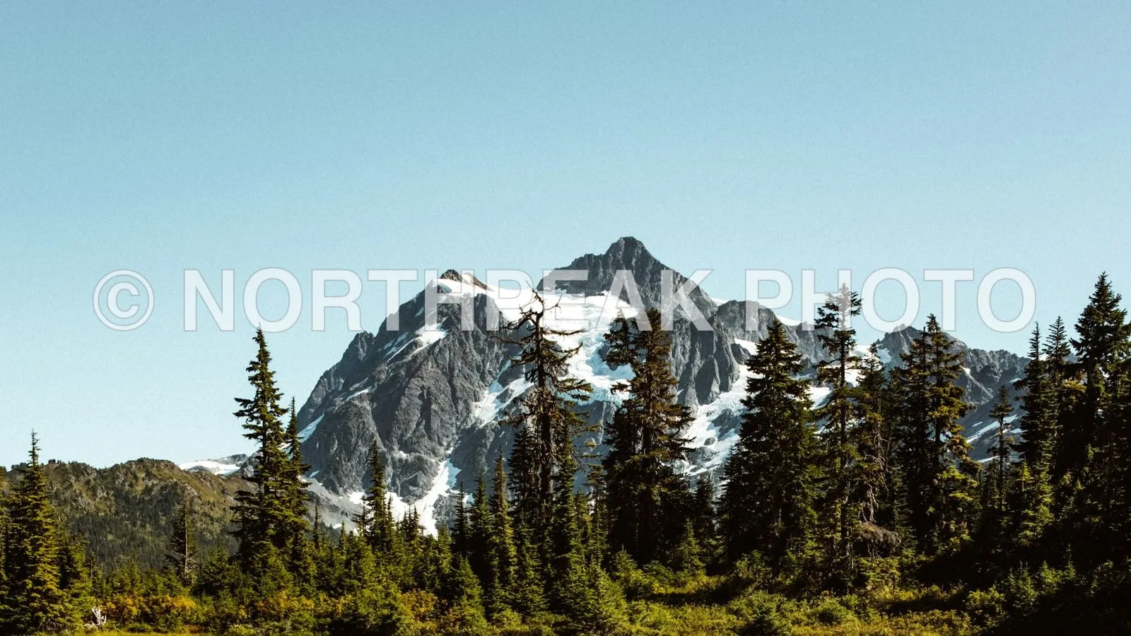 Before: Mountain landscape with a large text watermark removed